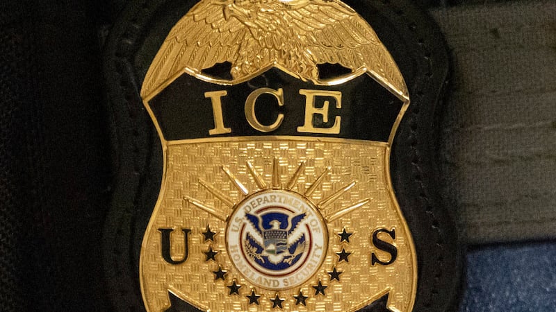 FILE - A federal agent wears an Immigration and Customs Enforcement badge, June 10, 2025, in...
