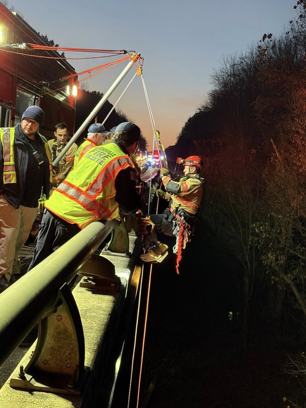 Clarksville Fire & Rescue attempts to rappel down to the Red River, where a vehicle crashed...